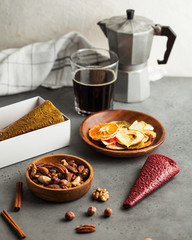 healthy snack, nuts, slices of dried fruit, homemade Apple candy without sugar, a Cup of coffee with a geyser coffee machine.