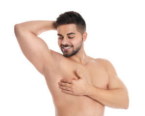 Fototapeta premium Young man showing hairless armpit after epilation procedure on white background