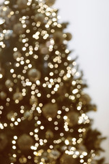 Vertical view of blurred christmas tree with garlands.
