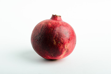 Ripe pomegranate studio shot on white background