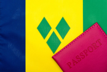 Against the background of the flag of Saint Vincent and the Grenadines is a passport.