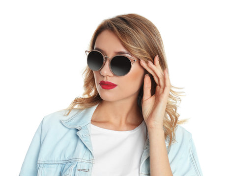 Young woman wearing stylish sunglasses on white background