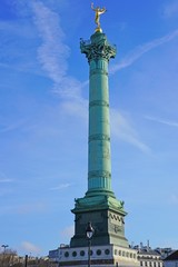 View of the green blue bronze July Column statue on the Place de la Bastille in Paris commemorating...