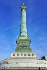 View of the green blue bronze July Column statue on the Place de la Bastille in Paris commemorating...