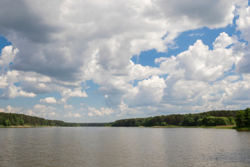 Cumulonimbus clouds over lake, abstract nature background