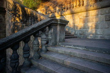 Old stone staircase with balusters and railings