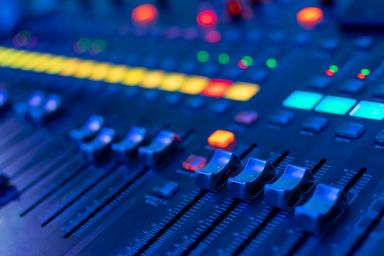 modern electronic mixing console in neon light. selective focus. closeup