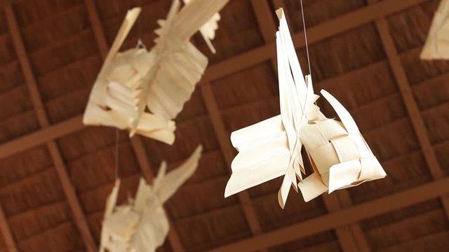 Thai traditional wind mobile weaving from lan or palm leaves in form of thai carp fish; Mobile Pla Ta-Piean. slow motion.