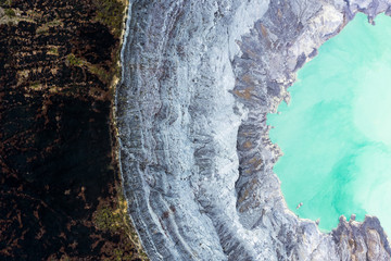View from above, stunning aerial view of the Ijen volcano with the turquoise-coloured acidic crater...