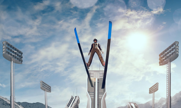 Skier in flight. Ski jumping on sunset.