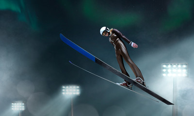 Skier in flight. Ski jumping in evening. - obrazy, fototapety, plakaty