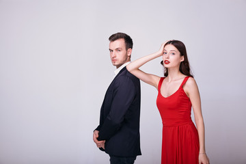 Fashion young couple on a white background in studio.