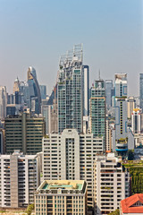 Fototapeta na wymiar Bangkok, Thailand – December 22, 2019 : Office Buildings, city and condominiums Area in Bangkok, Office Building in City, Modern Building, Businesses Building. Sky view from Asoke area. with blue sky.