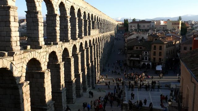 High perspective view of people near the ancient Roman aqueduct in Segovia, Spain on a sunny day