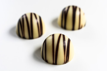  Three white chocolate candies isolated on a white background.