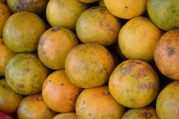 Oranges on the hand ready to sell in Thai market