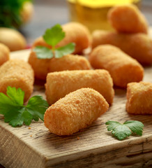 Homemade Potato Croquettes with dipping sauce on wooden board