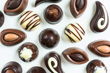  Background of different chocolates on a white background. Flat lay