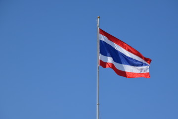 Thailand National Flag on the pole with blue sky.