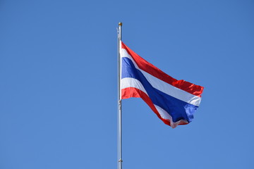 Thailand National Flag on the pole with blue sky.