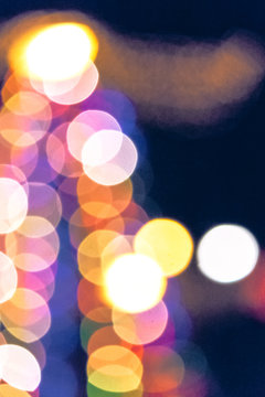 christmas lights on the streets at night. abstract blurred background toned in blue