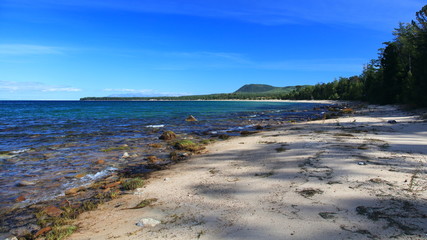 Long sandy beach with clear blue water