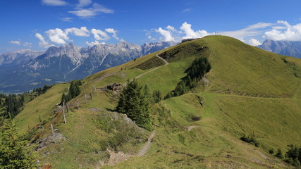 Lovely green mountains with mighty rocky ridge in the background
