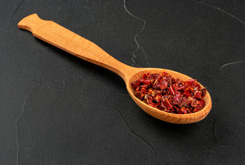 Pieces red pepper in spoon