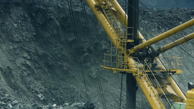 excavator loads huge quarry dump truck