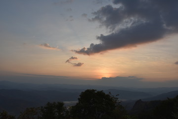 Morning clouds with the sunrise on foggy landscape