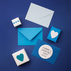 Blue envelopes, gifts and white hearts on classic blue