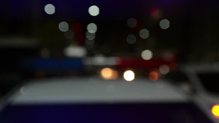 Police emergency lights flashing at a crime scene at night. Flashlights. Car accident and traffic jam. Flashing blue and red lights and signals on patrol car. Emergency car in action. Police raid and 