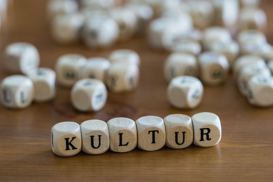 culture written in german with wooden cubes
