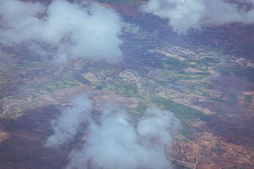 Views of the earth between clouds from an airplane