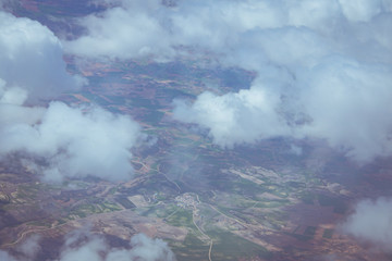 Views of the earth between clouds from an airplane