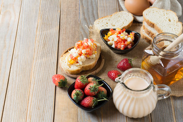 Breakfast bread with strawberry milk And eggs laid on the old wooden floor with copy space