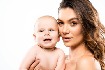 portrait of attractive naked mother holding smiling baby, isolated on white