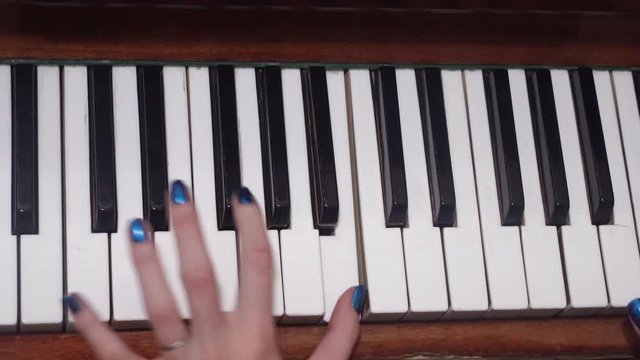 woman plays the old piano, top view and side view, close up, fingers press the keys.