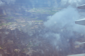 Views of the earth between clouds from an airplane