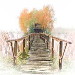Hunter and fisherman's house with wooden footbridge on an island in the middle of a river. Stary...
