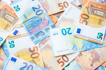 Obraz na płótnie Canvas Background of 20 and 50 value Euro money bill close up