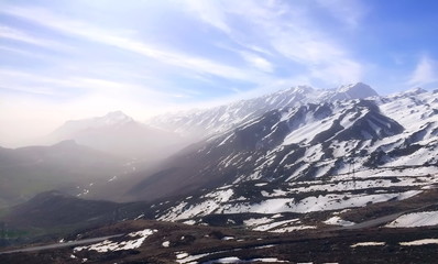 Snowy mountains surprised by morning light clouds