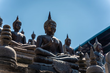 Buddhist statues against the blue sky
