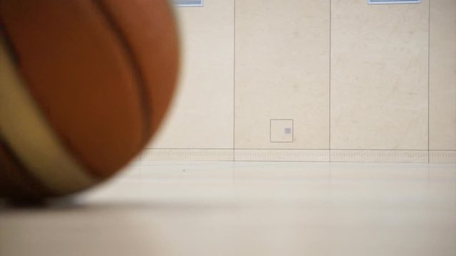Basketball rolling through a gym