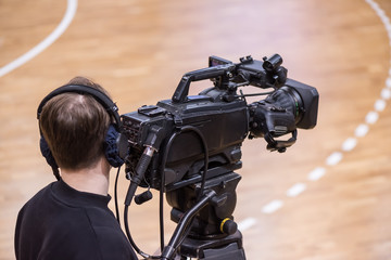 The operator shoots a sports match with a camcorder