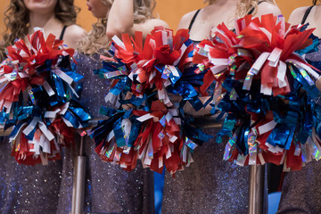 Cheerleaders in a sports match hold Pom Pom