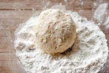 Russian traditional syrniki raw uncooked cottage cheese pancakes on old wooden background breakfast
