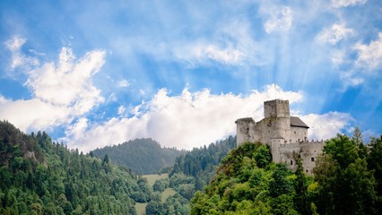 Fototapeta na wymiar Medieval castle on the green hill and sky with sun rays. Beautiful nature. Niedzica, Poland, 16:9 panoramic format