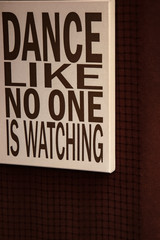 white box on dark background with the phrase dance like no one is watching