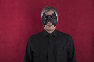 man in bat mask on a red background
